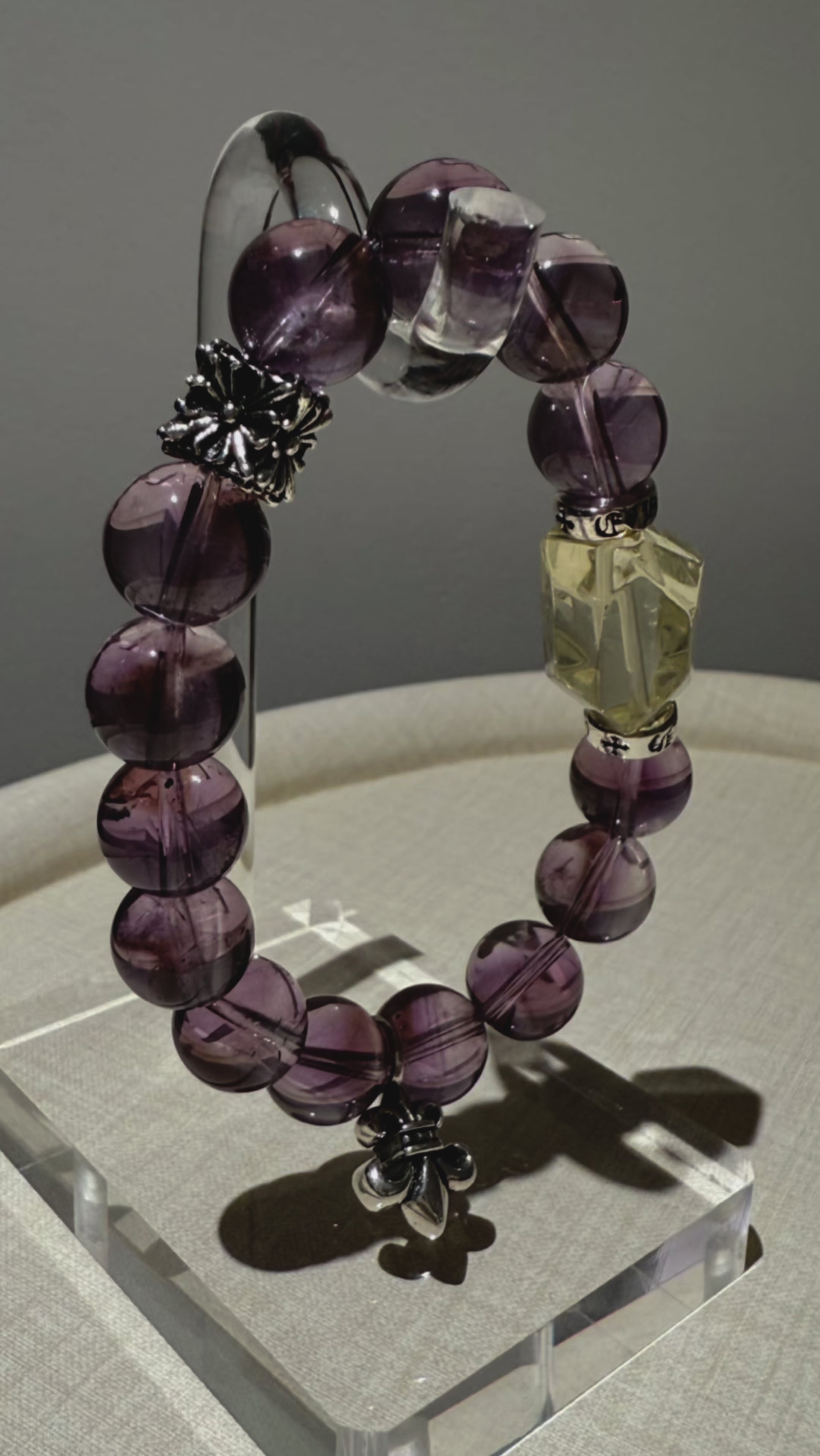Twilight poetry for your arm—14 velvety amethyst orbs circle a wild sun-kissed citrine, flecked with sterling stardust in a hand-strung love letter.