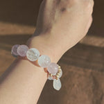 Hand-strung Rose Quartz, White Phantom Quartz, and an agate bunny slider make this crystal bracelet.