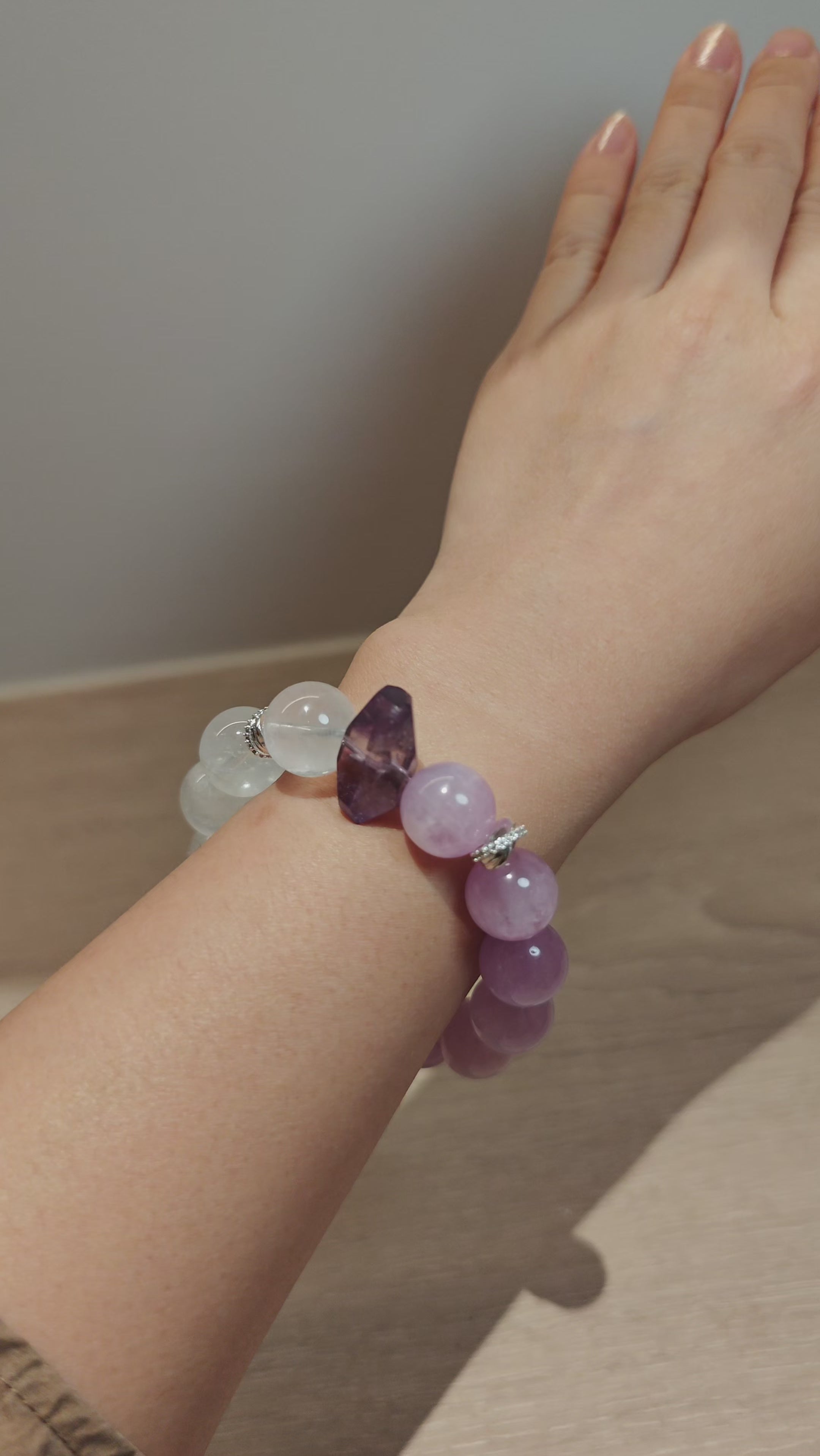 This is a multi gemstones bracelet consists of Kunzite, White Phantom Quartzs and Raw Amethysts. The beads are between 14.5 and 15.5mm. And in the bracelets, there are  hypoallergenic silver spacers and floral accents.