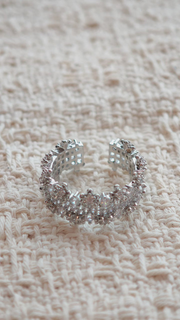 This snowflake zircon open ring features an intricate and textured band, adorned with clusters of sparkling zircon stones that mimic delicate snowflakes. Its adjustable open design ensures a comfortable fit, while the polished copper alloy metal reflects light beautifully, creating an elegant, frosty aesthetic. The detailed craftsmanship gives it a luxurious, eye-catching appearance ideal for adding a wintry charm to any look.