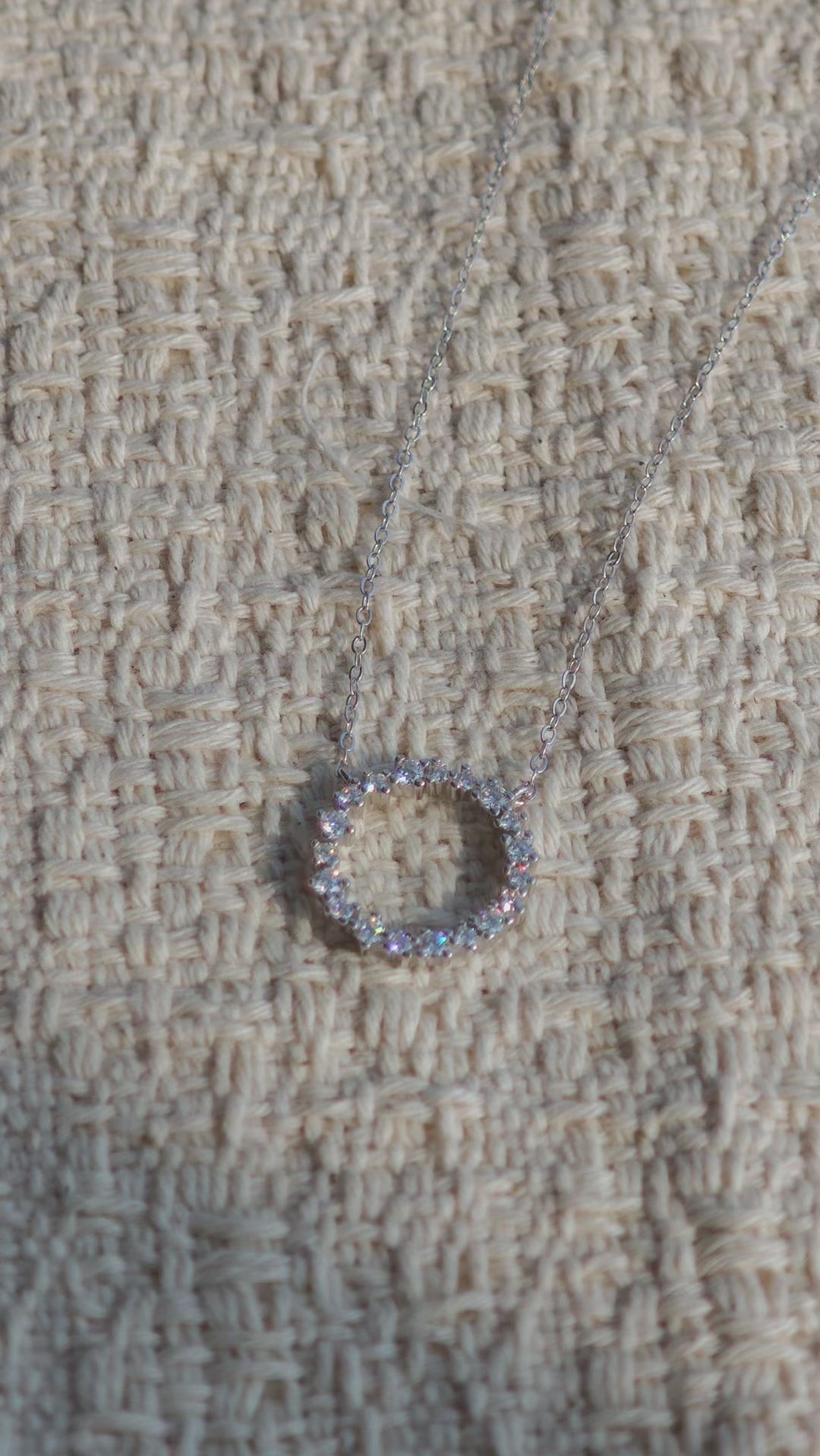 This S925 silver necklace features a delicate circular pendant encrusted with shimmering moissanite stones, forming an elegant open-circle silhouette. The slender silver chain complements the pendant perfectly, lending a refined and timeless charm to the piece. Its minimalist yet sparkling design makes it a versatile accessory for various occasions.