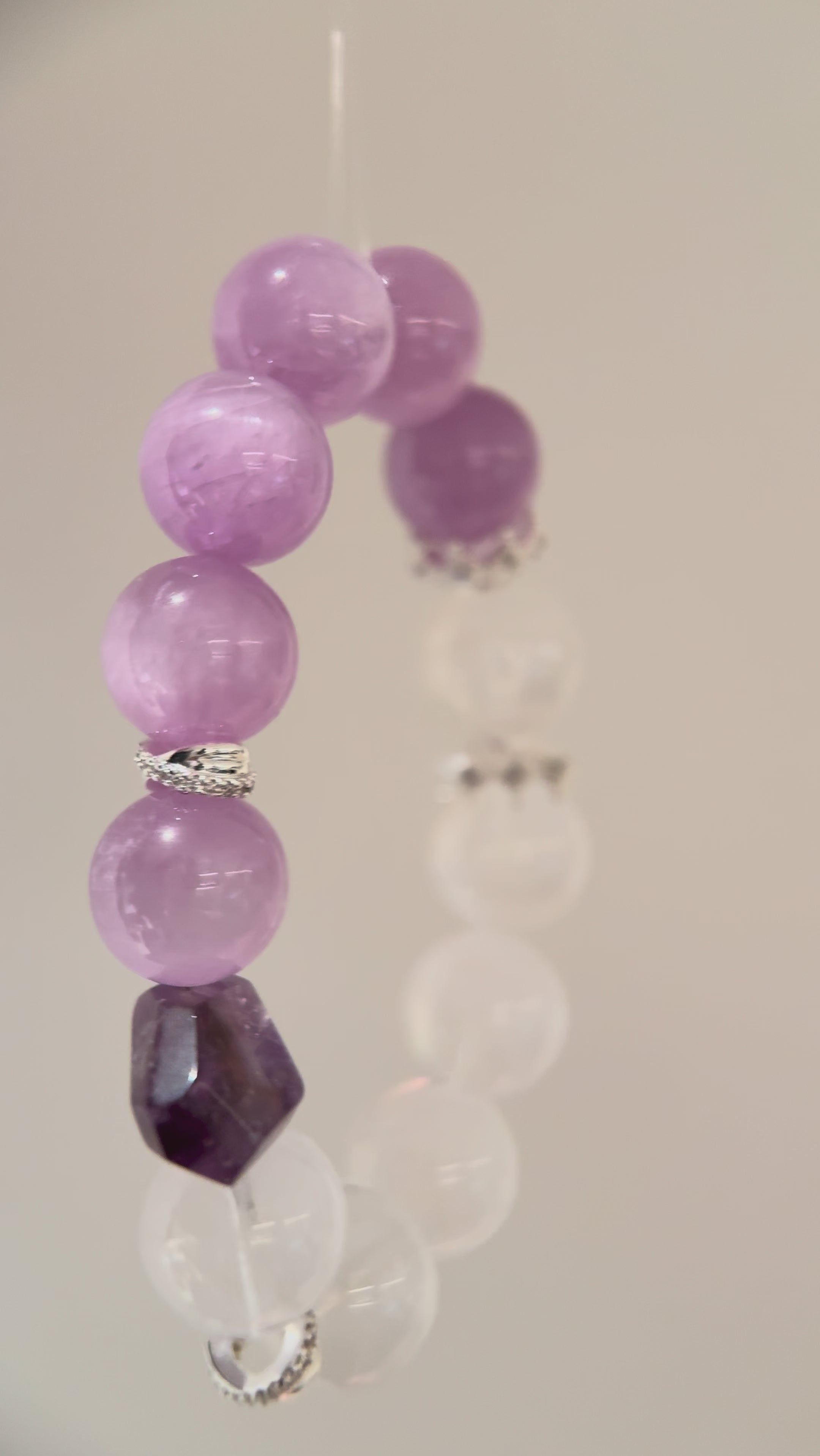 This is a multi gemstones bracelet consists of Kunzite, White Phantom Quartzs and Raw Amethysts. The beads are between 14.5 and 15.5mm. And in the bracelets, there are  hypoallergenic silver spacers and floral accents.