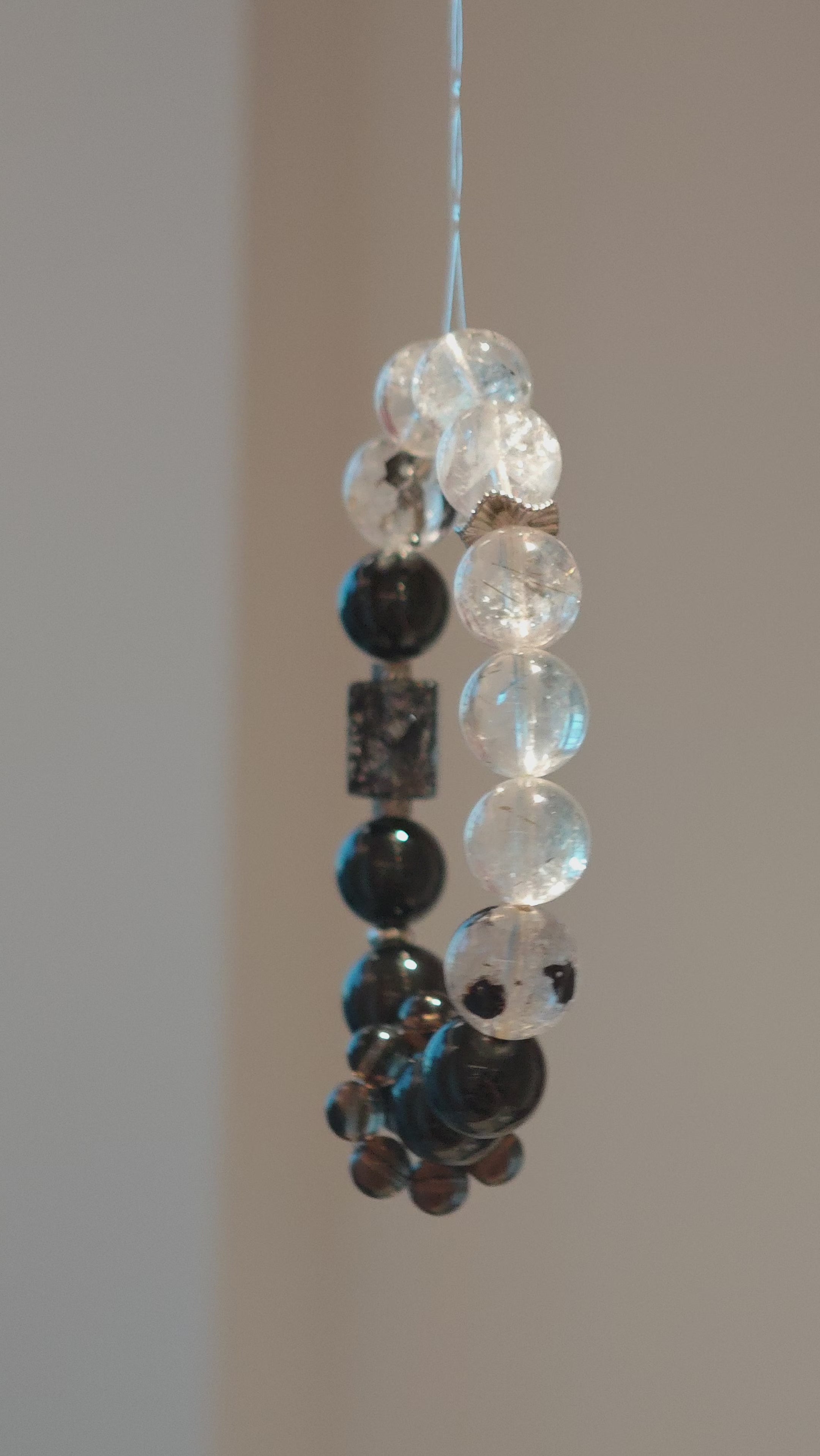 This is a crystal bracelet consists of Black Gold Ultra-Sparkle Azeztulite, Herkimer Diamond, Lace Black Rutilated Quartz, Obsidian and Tea Citrine Running Ring.