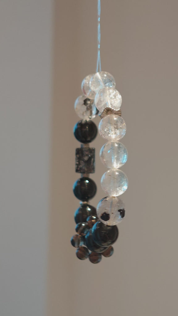 This is a crystal bracelet consists of Black Gold Ultra-Sparkle Azeztulite, Herkimer Diamond, Lace Black Rutilated Quartz, Obsidian and Tea Citrine Running Ring.